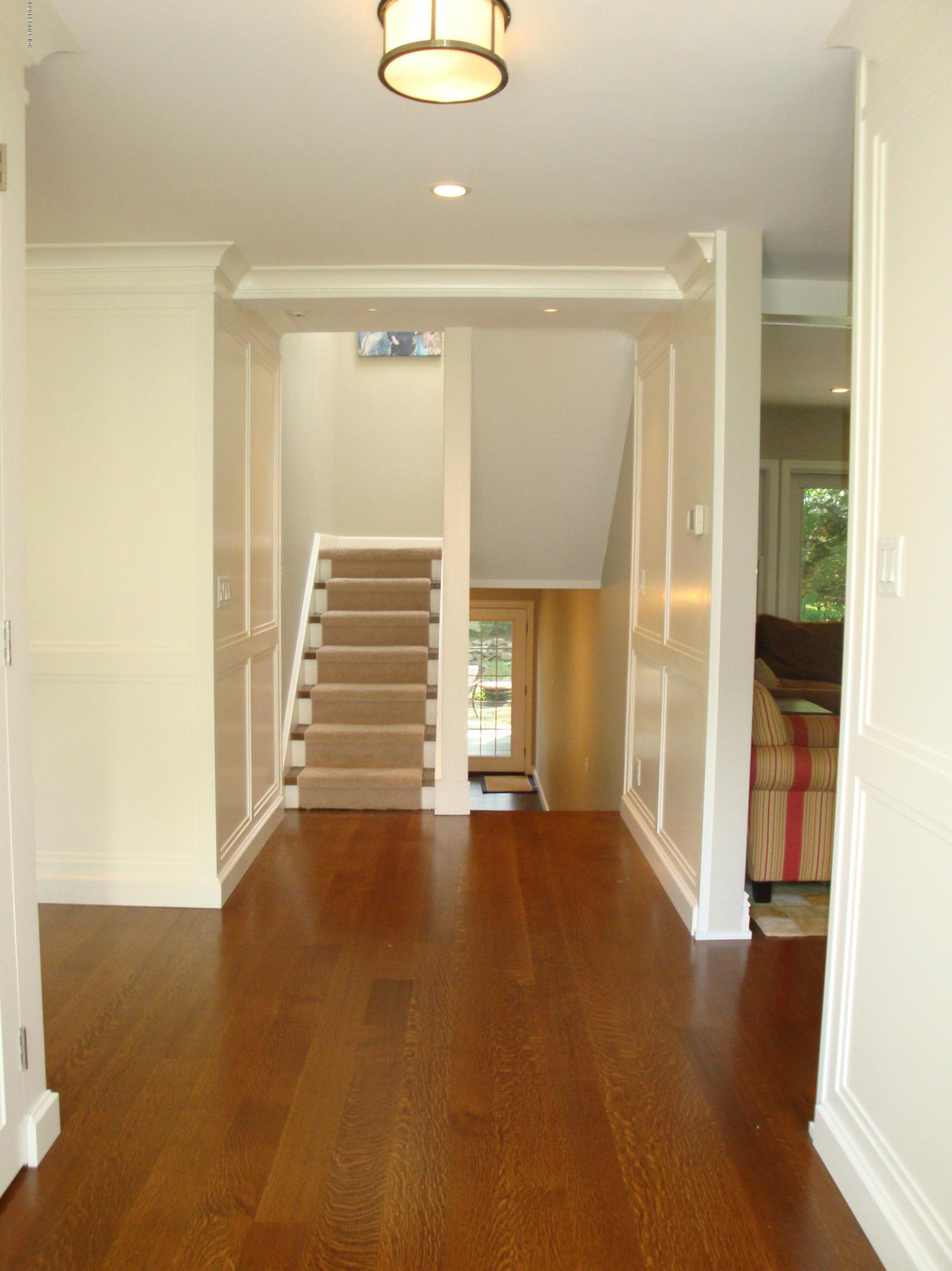 18 Hidden Brook Road Riverside, CT 06878 - Photo 3 of 32 a view of an empty room with wooden floor and a window