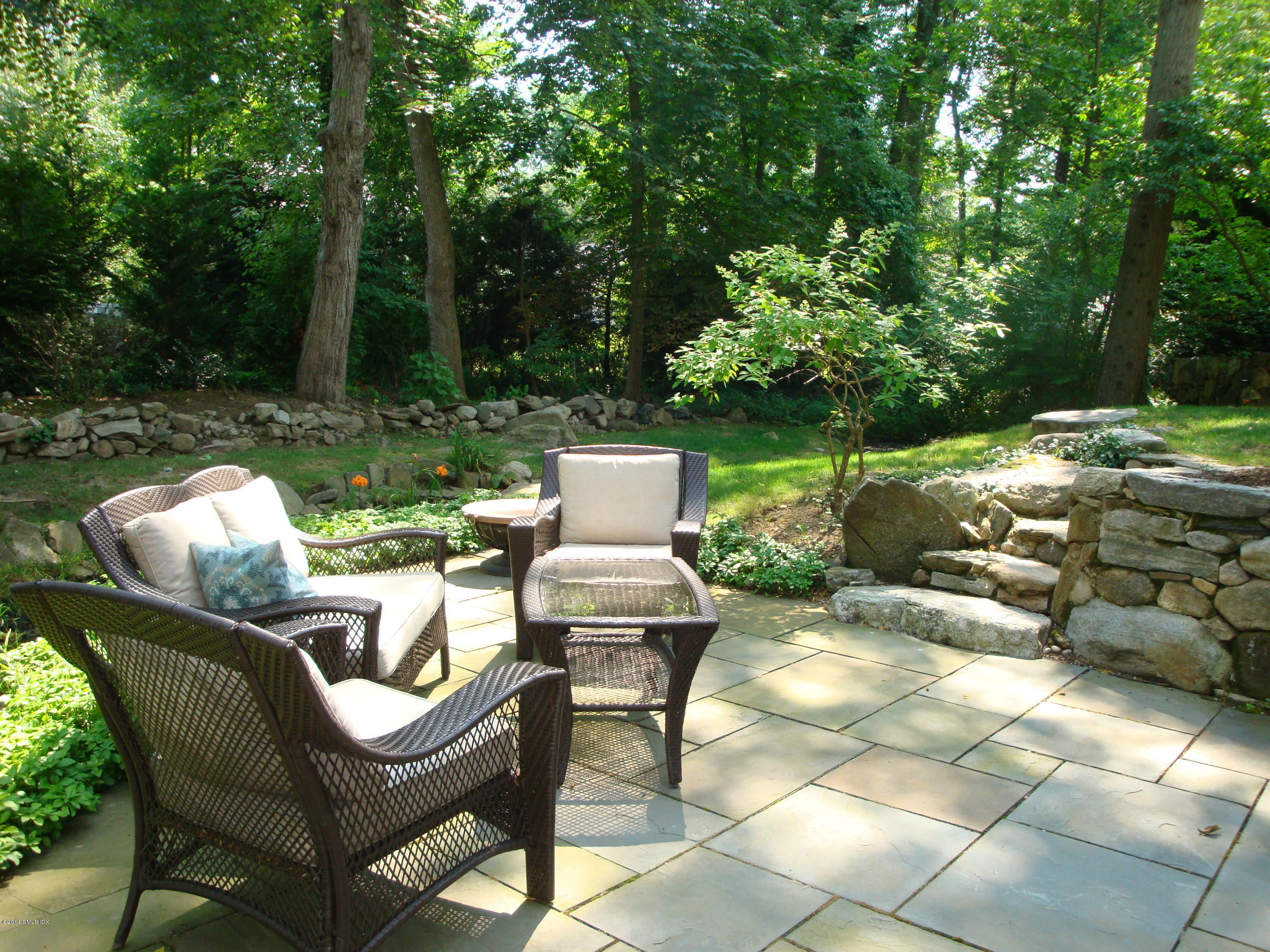 18 Hidden Brook Road Riverside, CT 06878 - Photo 31 of 32 a view of a chairs and table in backyard