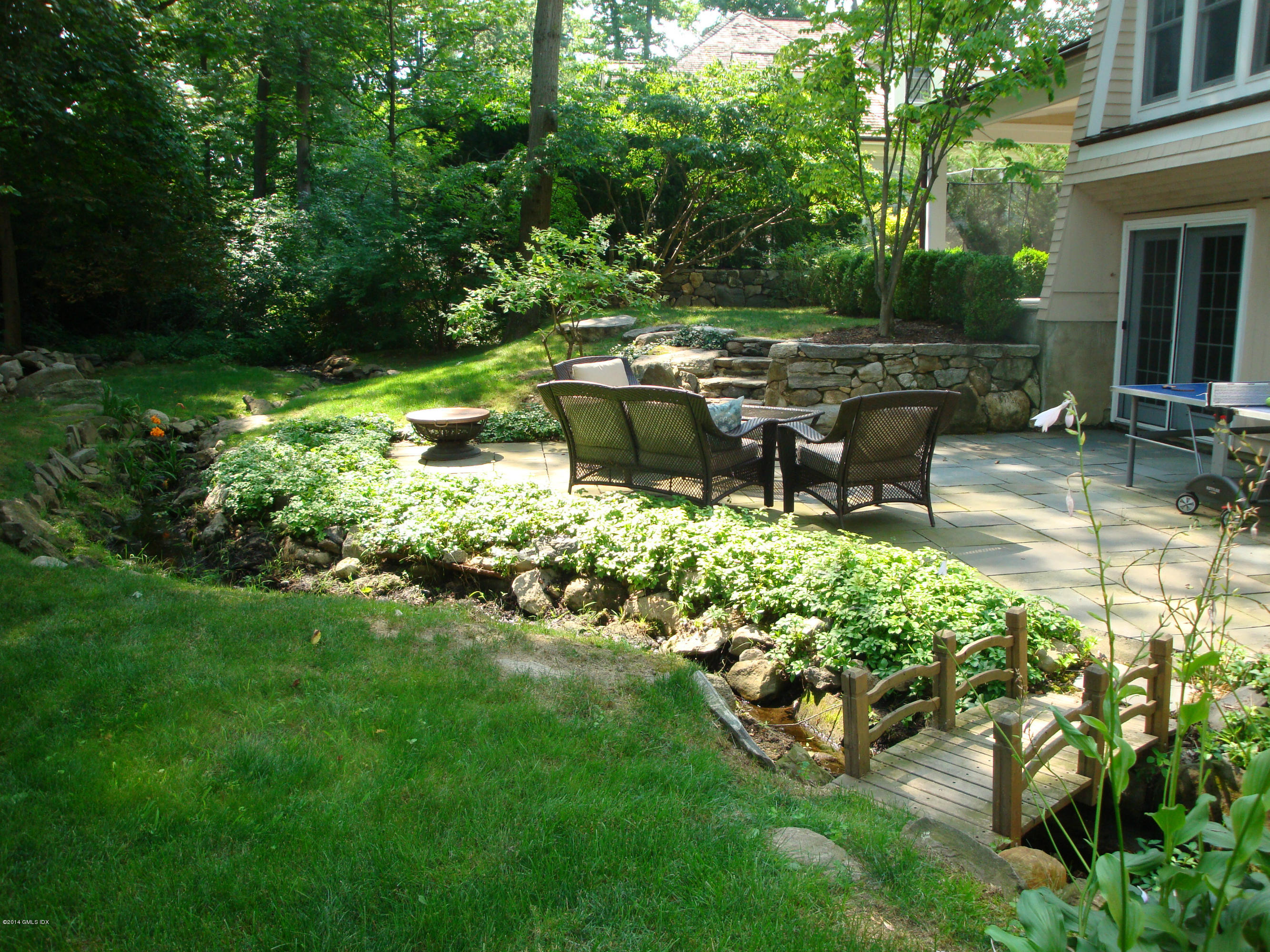 18 Hidden Brook Road Riverside, CT 06878 - Photo 32 of 32 a garden with lots of green space and bench