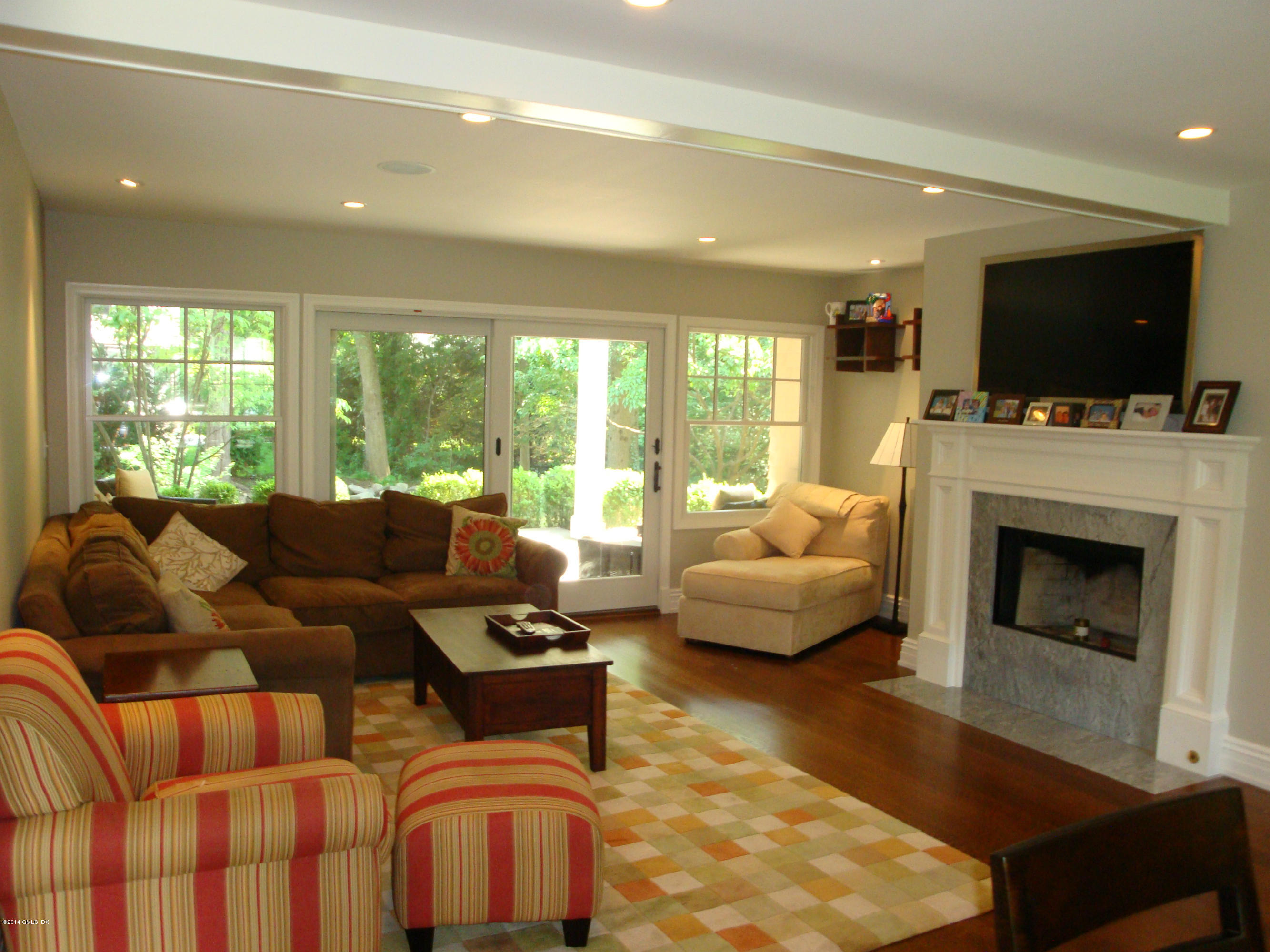 18 Hidden Brook Road Riverside, CT 06878 - Photo 4 of 32 a living room with furniture fireplace and a flat screen tv