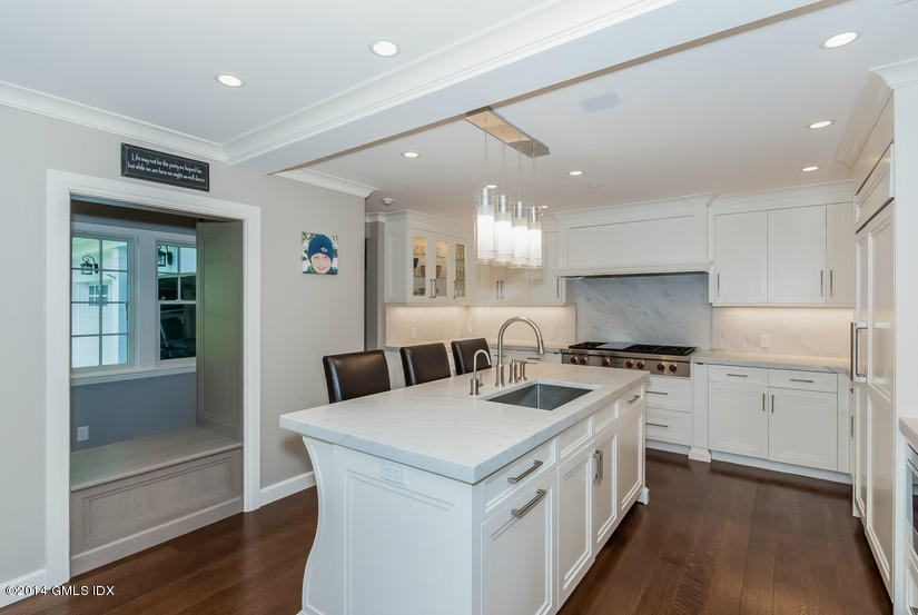 18 Hidden Brook Road Riverside, CT 06878 - Photo 7 of 32 a kitchen that has a lot of white cabinets and wooden floor