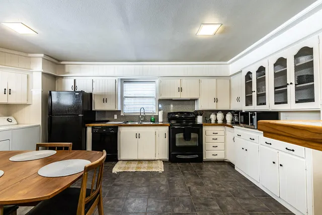 a kitchen with stainless steel appliances a stove a sink a refrigerator and cabinets
