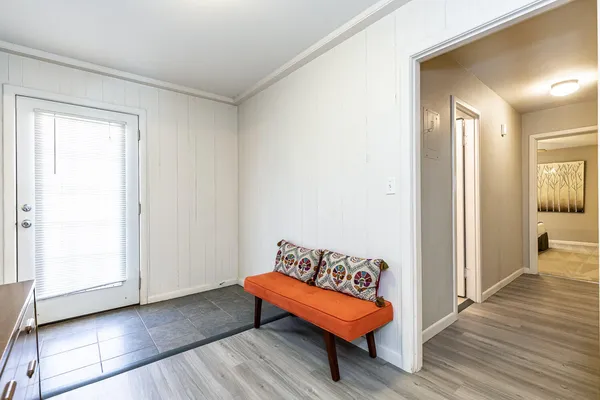 a spacious bedroom with a bed and wooden floor