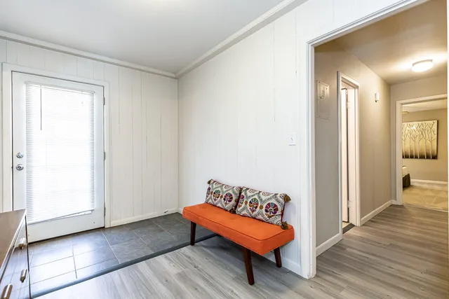 a spacious bedroom with a bed and wooden floor