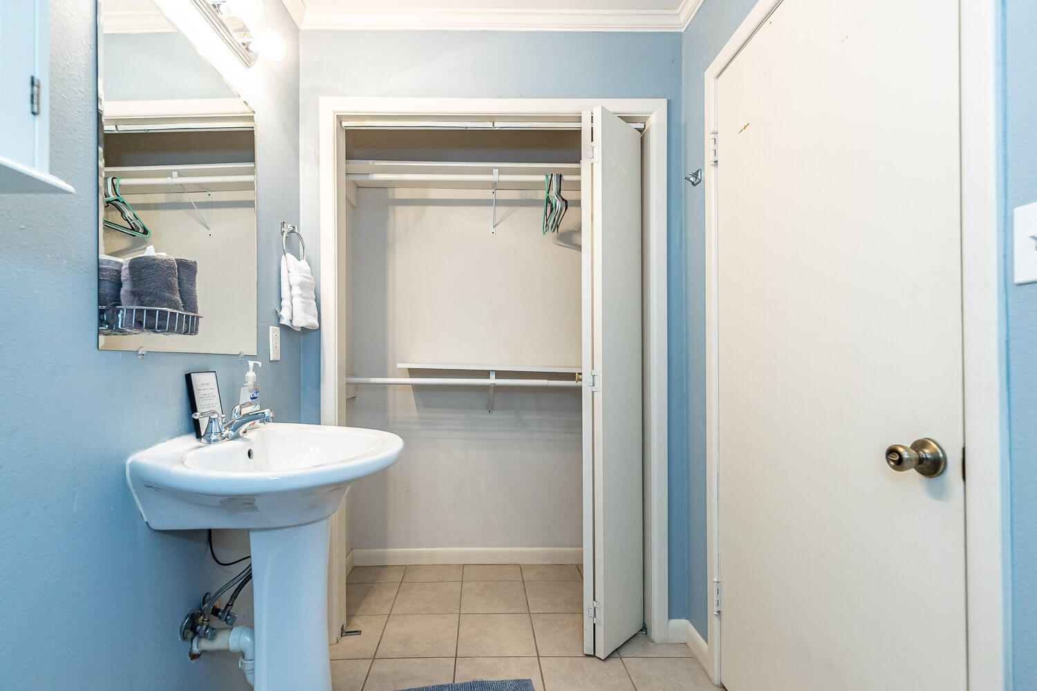 3504 38th Street Lubbock, TX 79413 - Photo 19 of 28 a bathroom with a sink a mirror and a window