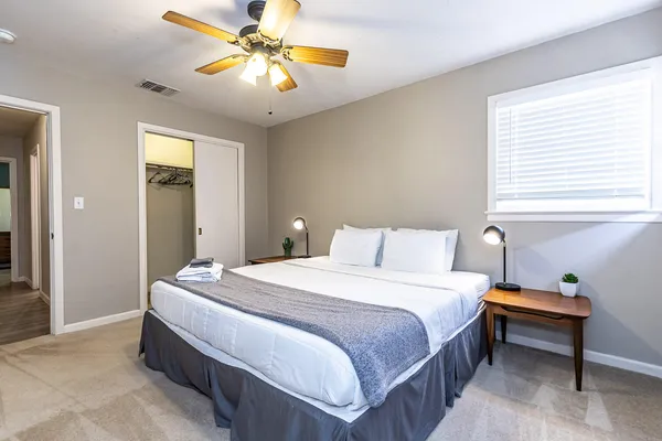 a bedroom with a bed and a chandelier