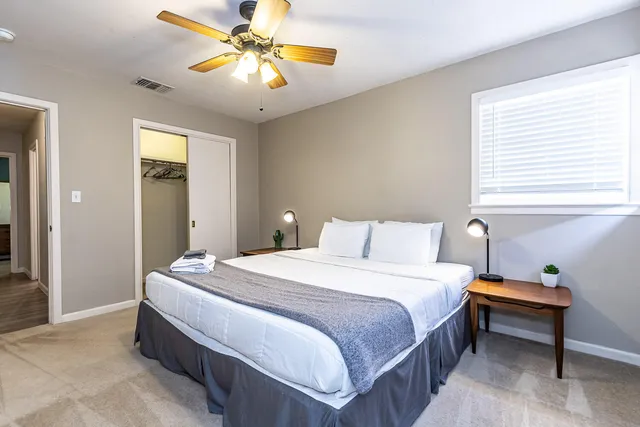 a bedroom with a bed and a chandelier