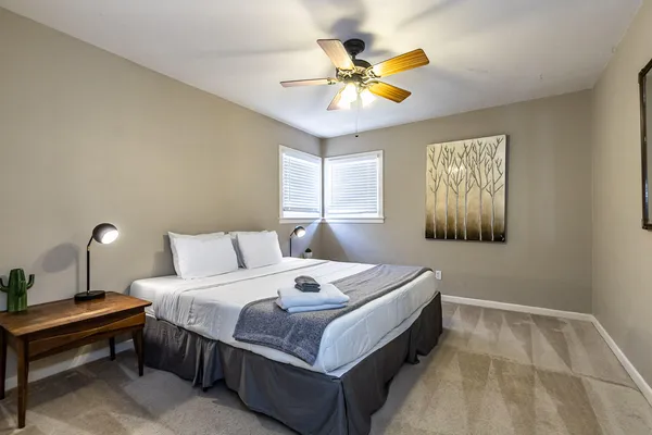 a bedroom with a bed and a chandelier