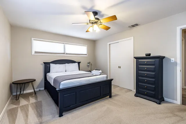 a bedroom with a bed and a chandelier