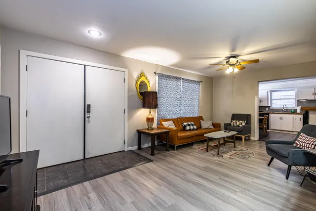 a living room with furniture and a chandelier