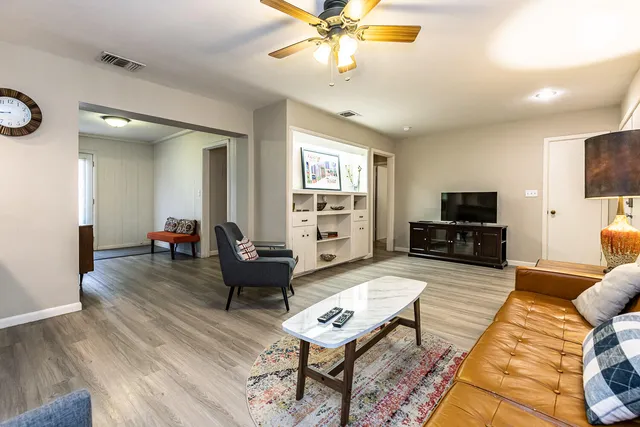 a living room with furniture and a flat screen tv