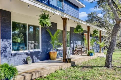 a kitchen with stainless steel appliances kitchen island granite countertop a table chairs in it and white cabinets