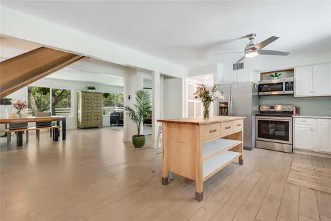 a dining room with furniture entryway and wooden floor