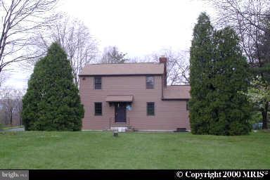 7538 Ridge Road Frederick, MD 21702 - Photo 1 of 15 a front view of a house with a garden