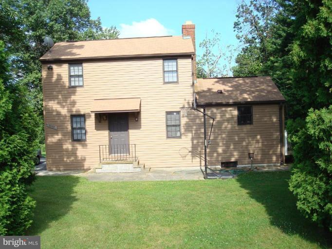 7538 Ridge Road Frederick, MD 21702 - Photo 2 of 15 a front view of a house with a garden