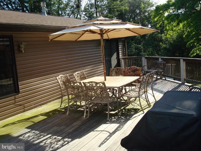 7538 Ridge Road Frederick, MD 21702 - Photo 14 of 15 a view of a patio with table and chairs under an umbrella