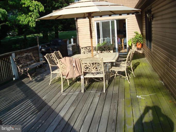 7538 Ridge Road Frederick, MD 21702 - Photo 15 of 15 a view of a patio with a dining table and chairs with wooden floor