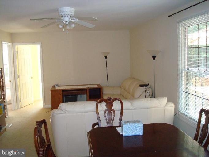 7538 Ridge Road Frederick, MD 21702 - Photo 5 of 15 a living room with furniture a ceiling fan and a window