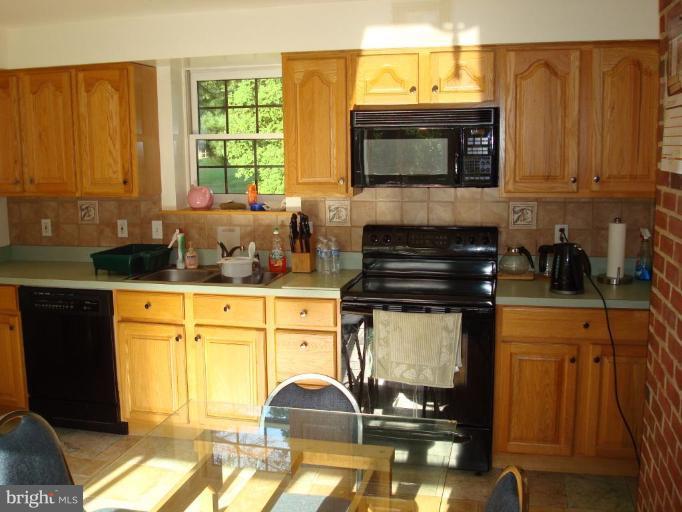 7538 Ridge Road Frederick, MD 21702 - Photo 7 of 15 a kitchen with stainless steel appliances a stove a sink and a microwave