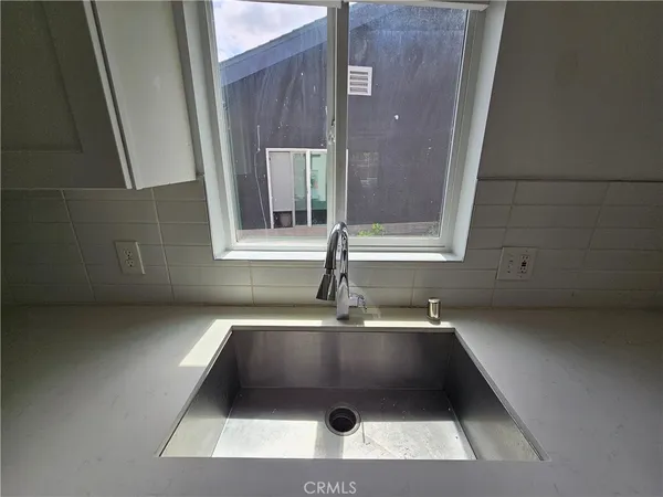 a bathroom with a sink and a window