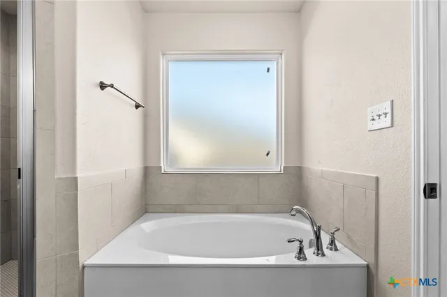 a white bath tub sitting next to a white sink