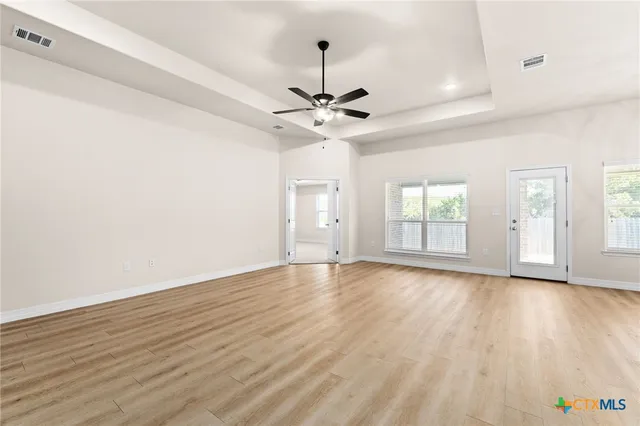 wooden floor in an empty room with a window