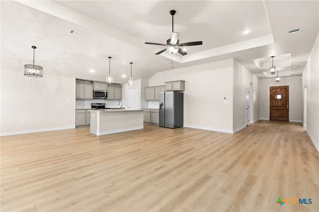 a view of a kitchen with a sink and a refrigerator