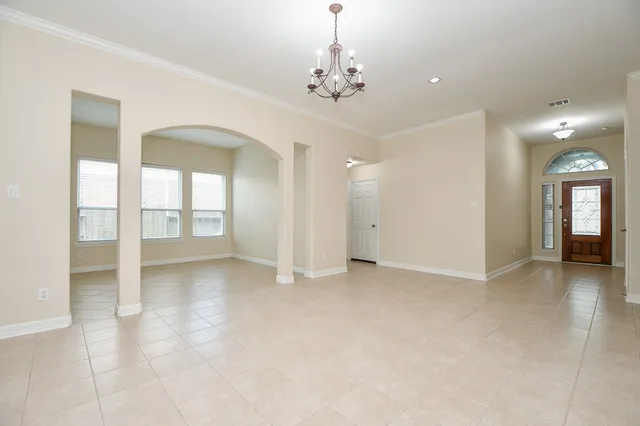 a kitchen with stainless steel appliances granite countertop a stove top oven a sink a dining table and chairs