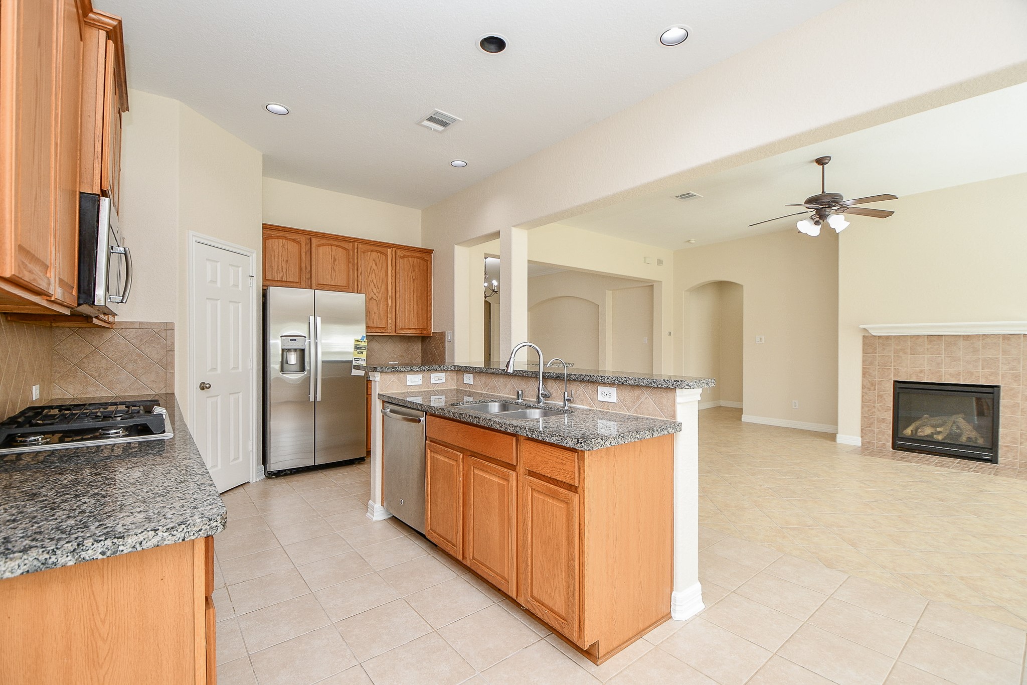 12104 Dawn Mist Court Pearland, TX 77584 - Photo 22 of 31 a kitchen with stainless steel appliances granite countertop a stove and a refrigerator