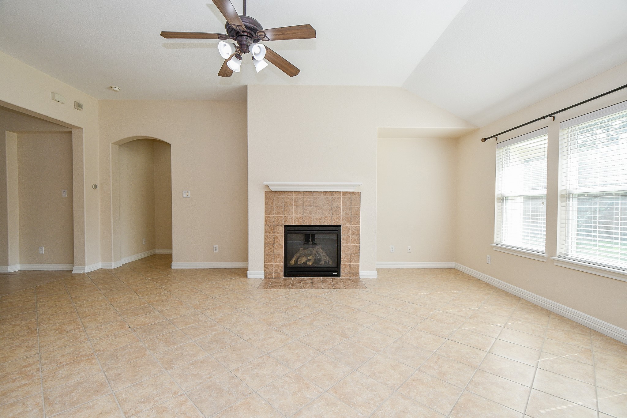 12104 Dawn Mist Court Pearland, TX 77584 - Photo 26 of 31 an empty room with windows and fireplace
