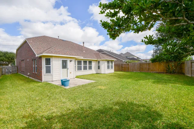 a view of a backyard with a garden and entertaining space