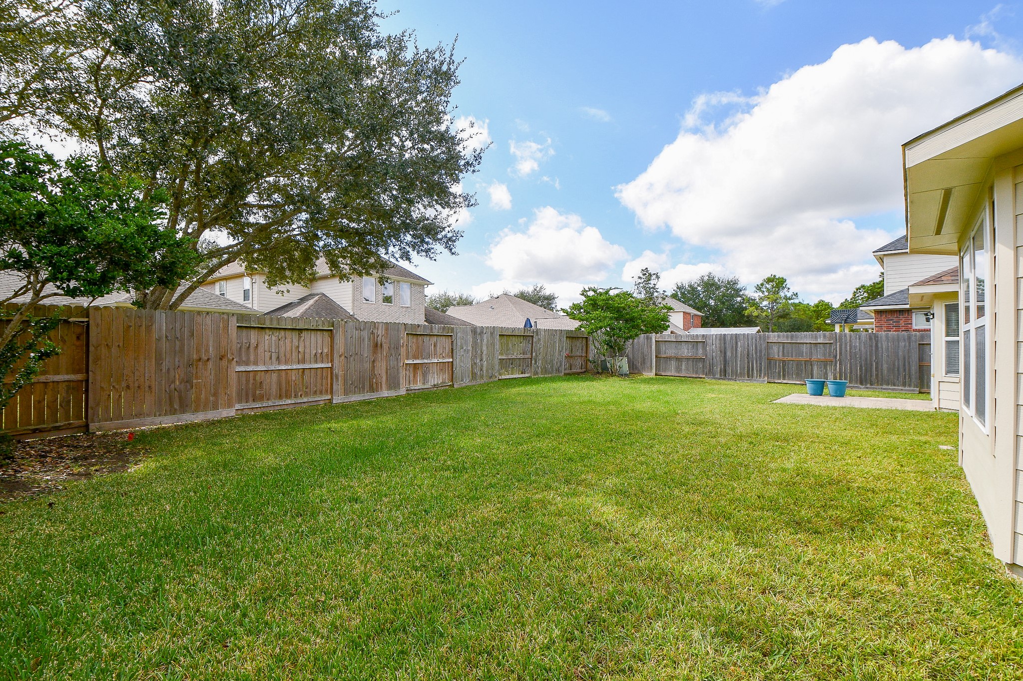 12104 Dawn Mist Court Pearland, TX 77584 - Photo 4 of 31 a view of a backyard with a garden and entertaining space