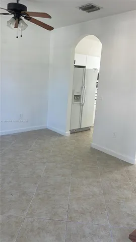 a view of a livingroom with wooden floor and a ceiling fan