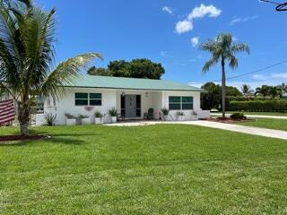 4600 Northeast 4th Avenue Boca Raton, FL 33431 - Photo 1 of 36 a front view of house with yard and outdoor seating