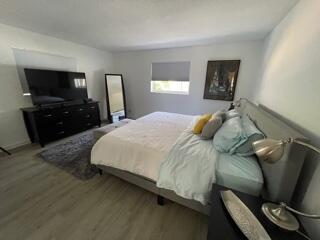 4600 Northeast 4th Avenue Boca Raton, FL 33431 - Photo 12 of 36 a bedroom with a bed and a television in it