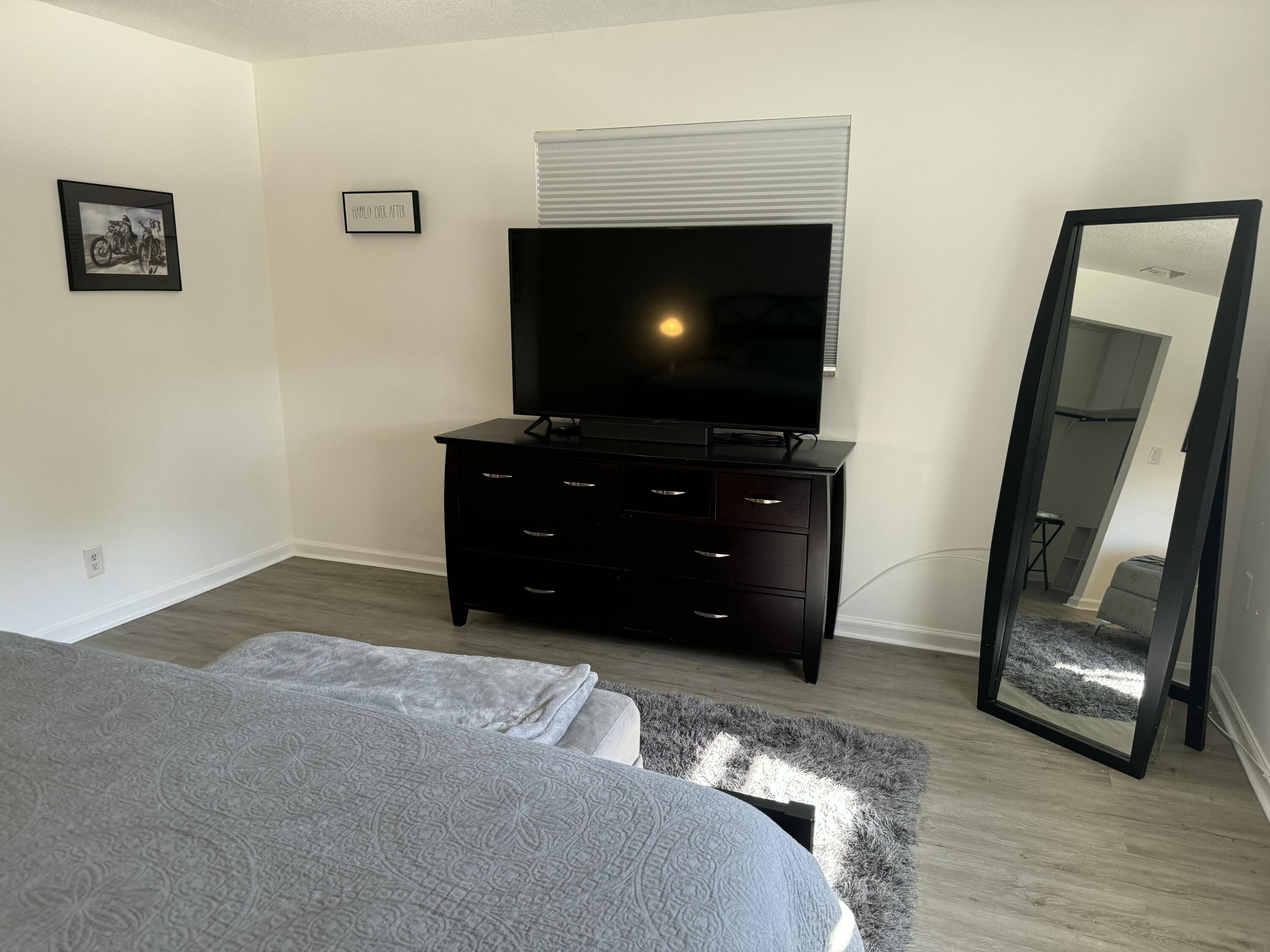 4600 Northeast 4th Avenue Boca Raton, FL 33431 - Photo 14 of 36 a room with furniture and a flat screen tv