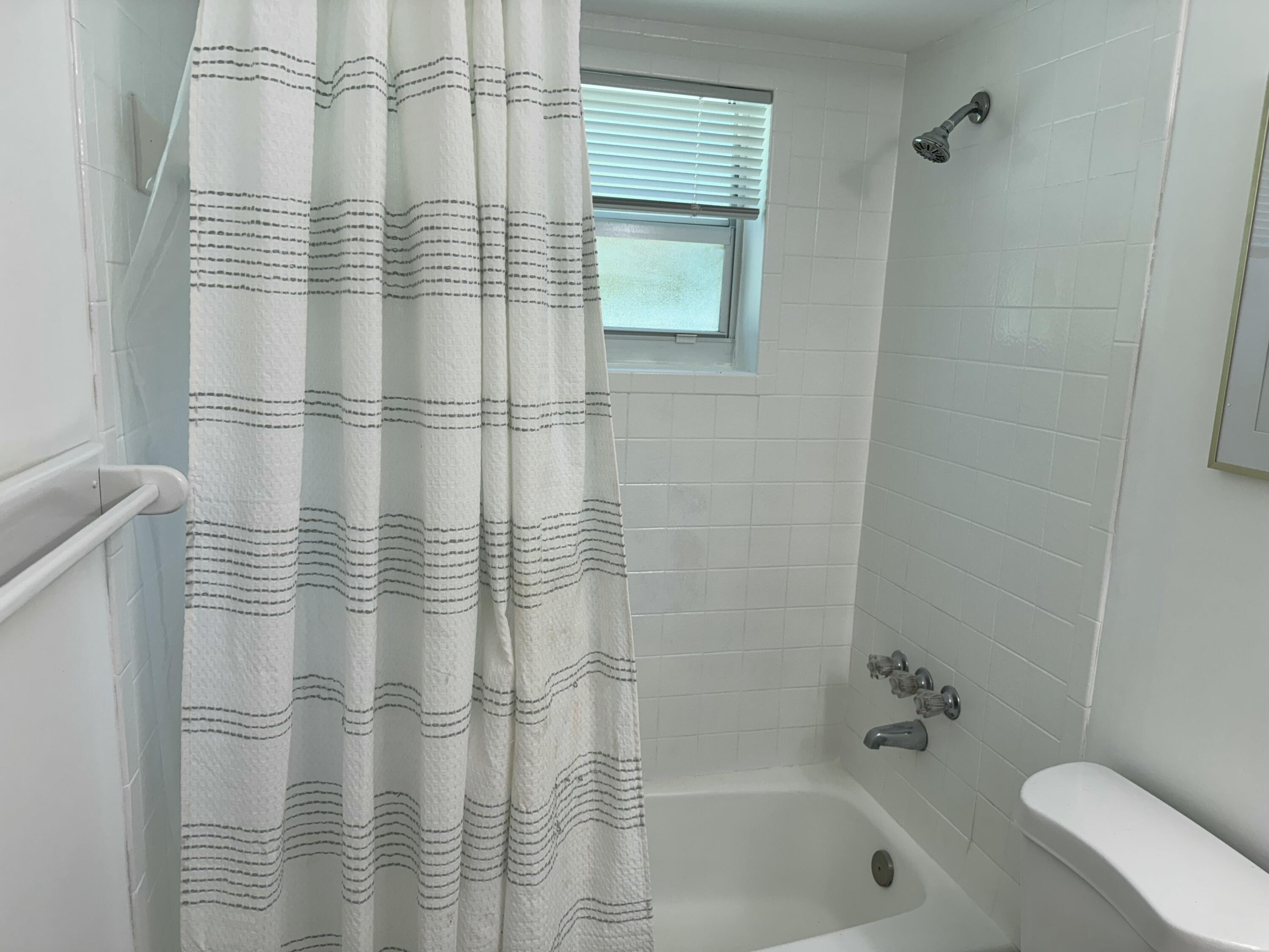 4600 Northeast 4th Avenue Boca Raton, FL 33431 - Photo 20 of 36 a bathroom with a shower curtain
