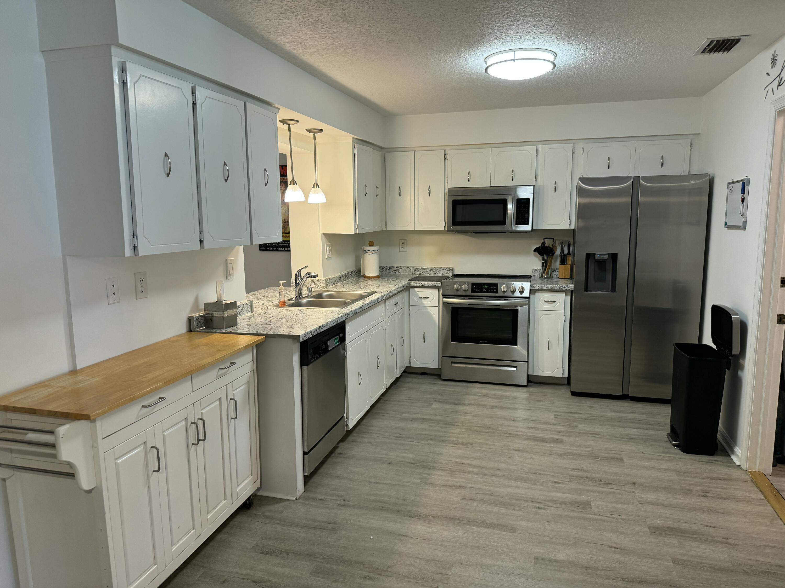4600 Northeast 4th Avenue Boca Raton, FL 33431 - Photo 2 of 36 a kitchen with cabinets stainless steel appliances a sink and a window