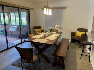 4600 Northeast 4th Avenue Boca Raton, FL 33431 - Photo 9 of 36 a view of a dining room with furniture wooden floor and a chandelier