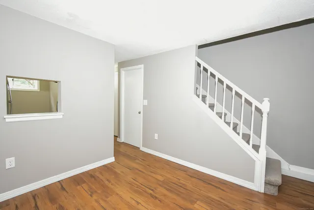 a view of an entryway with wooden floor