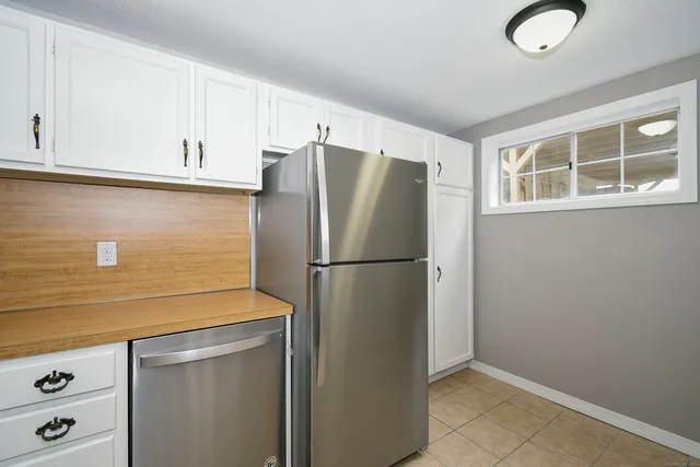a white refrigerator freezer sitting inside of a kitchen
