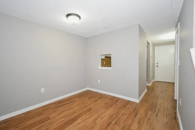 a view of a room with wooden floor