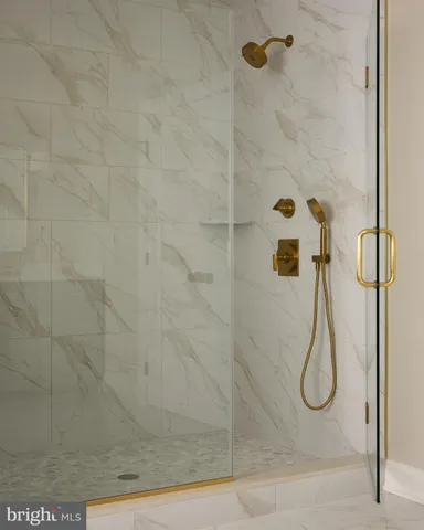 a bathroom has a glass shower door