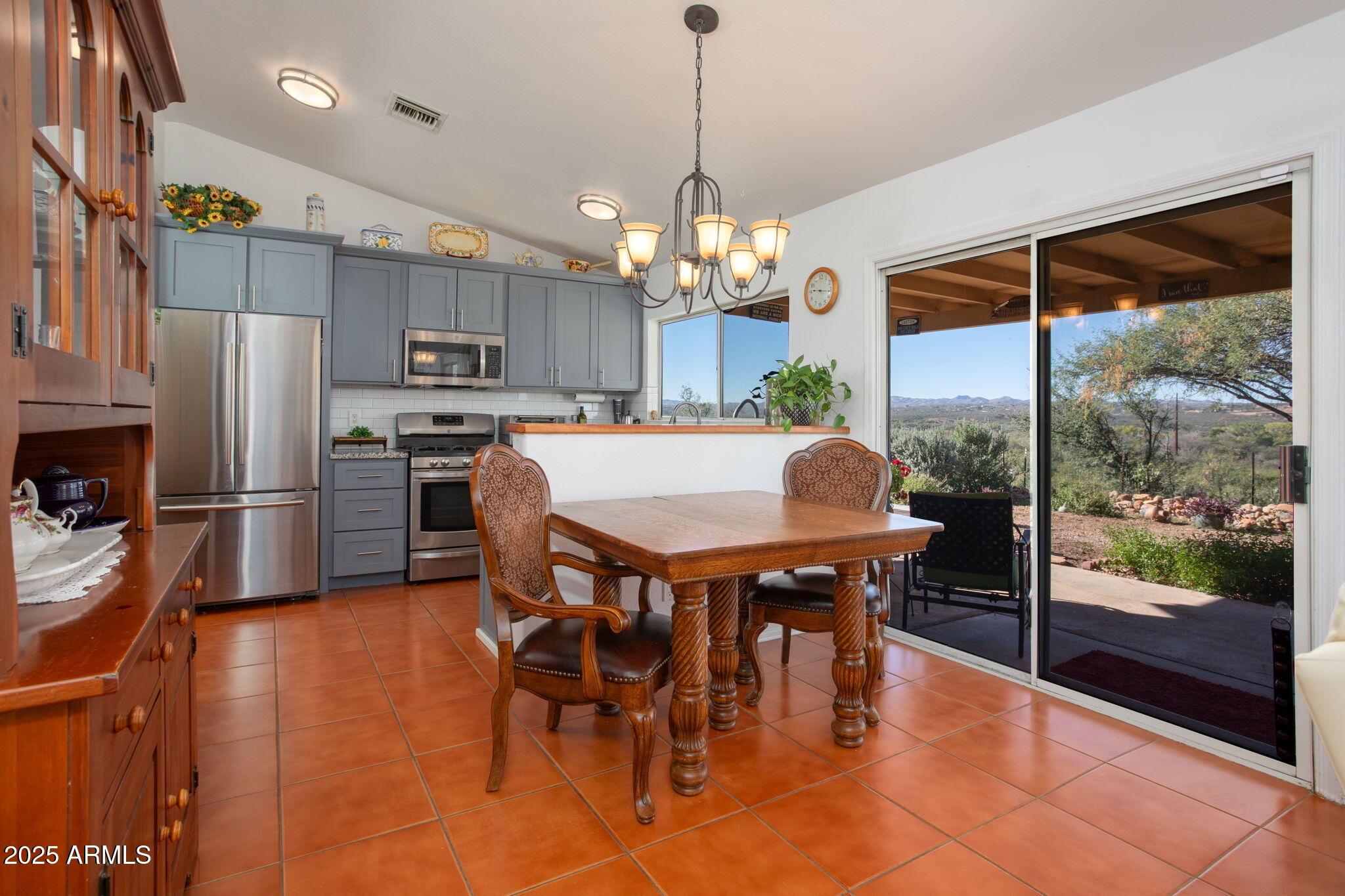 418 Cancun Court Rio Rico, AZ 85648 - Photo 11 of 36 a dining table chair next to a window with kitchen view