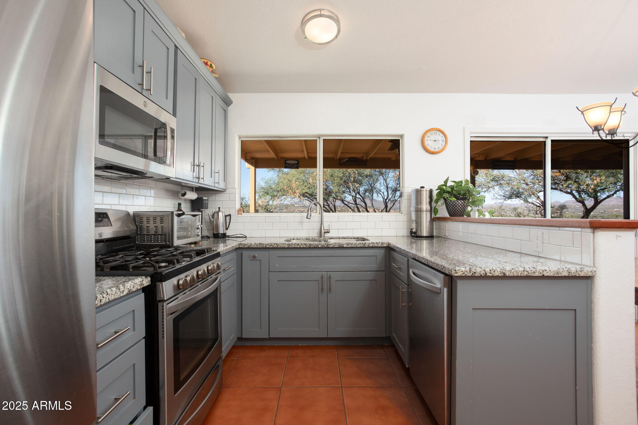 418 Cancun Court Rio Rico, AZ 85648 - Photo 12 of 36 a kitchen with stainless steel appliances granite countertop a stove and a sink