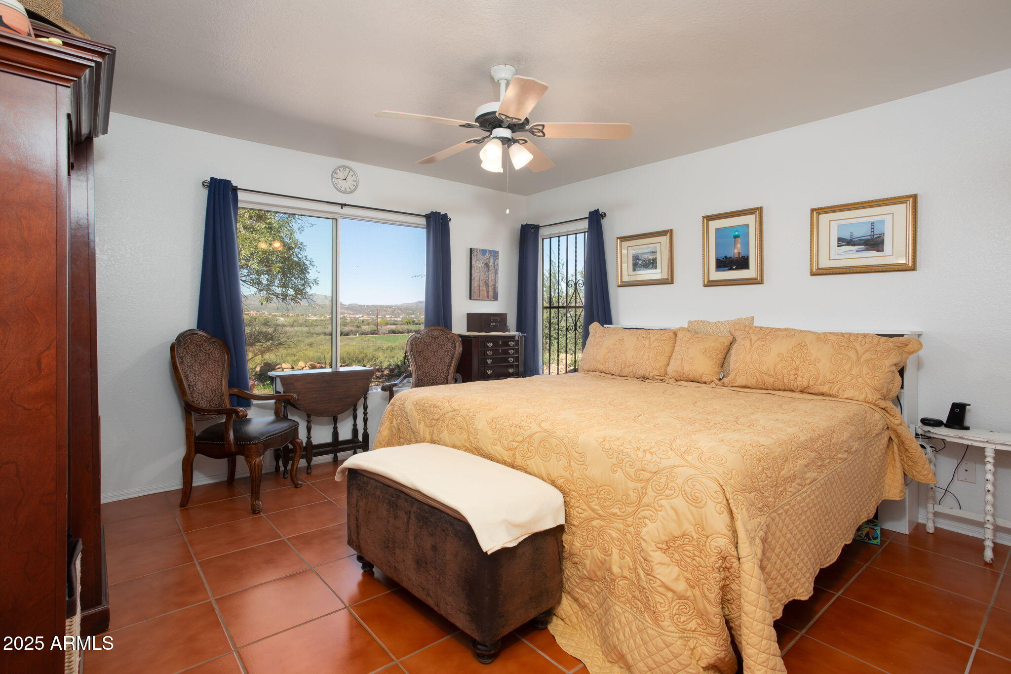 418 Cancun Court Rio Rico, AZ 85648 - Photo 15 of 36 a spacious bedroom with a bed and a chandelier