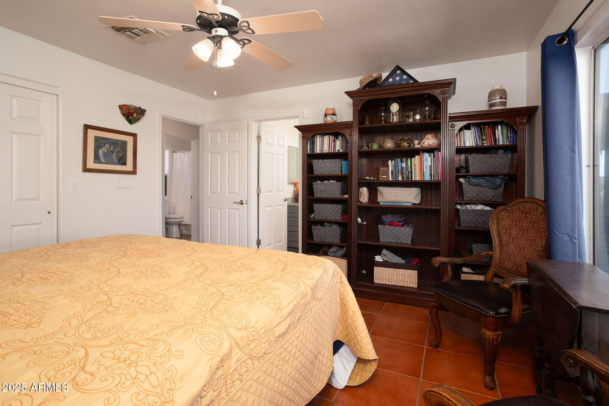 418 Cancun Court Rio Rico, AZ 85648 - Photo 17 of 36 a bed room with a bed and a book shelf