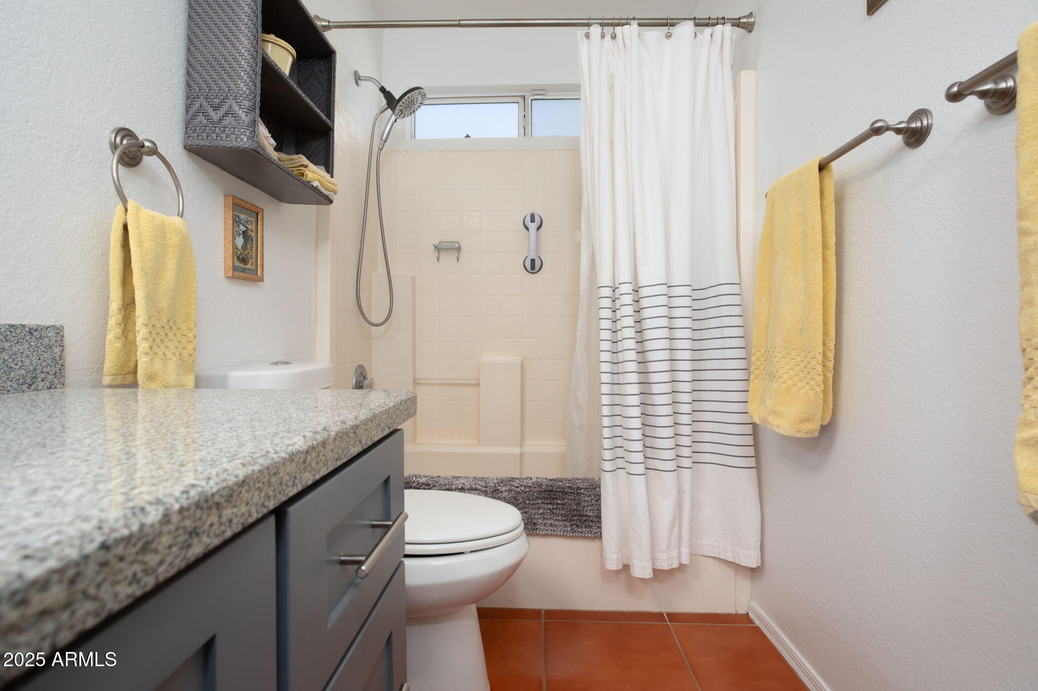 418 Cancun Court Rio Rico, AZ 85648 - Photo 19 of 36 a bathroom with a granite countertop sink a toilet and shower
