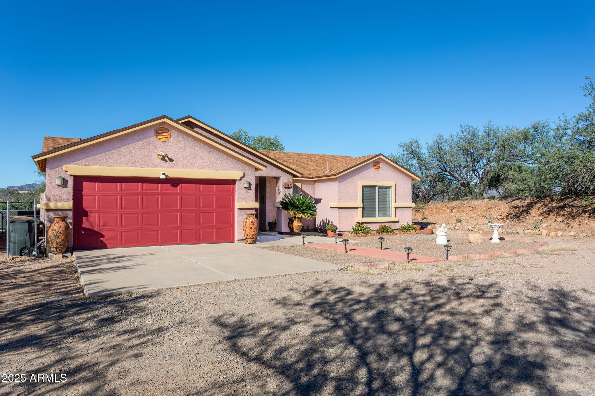418 Cancun Court Rio Rico, AZ 85648 - Photo 2 of 36 a front view of a house with a yard and garage
