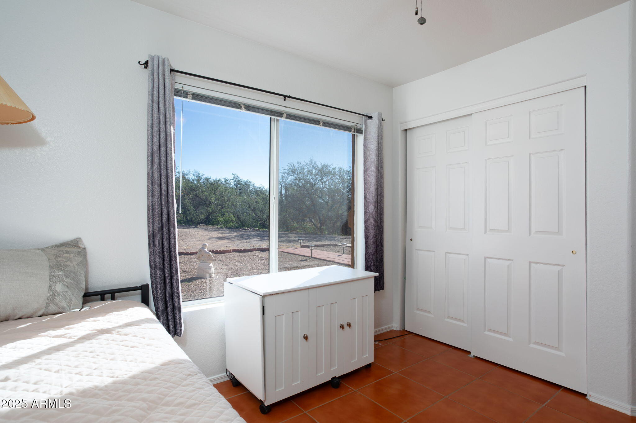 418 Cancun Court Rio Rico, AZ 85648 - Photo 21 of 36 a room with a bed and a large window